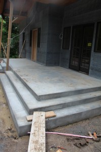 The future pergola in the foreground, with the front door porch in the background