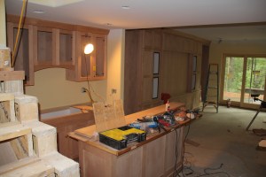 A view from the stairs of the basement bar and media center wall