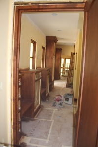 The front hall looking from the laundry room towards the entry and stairwell.